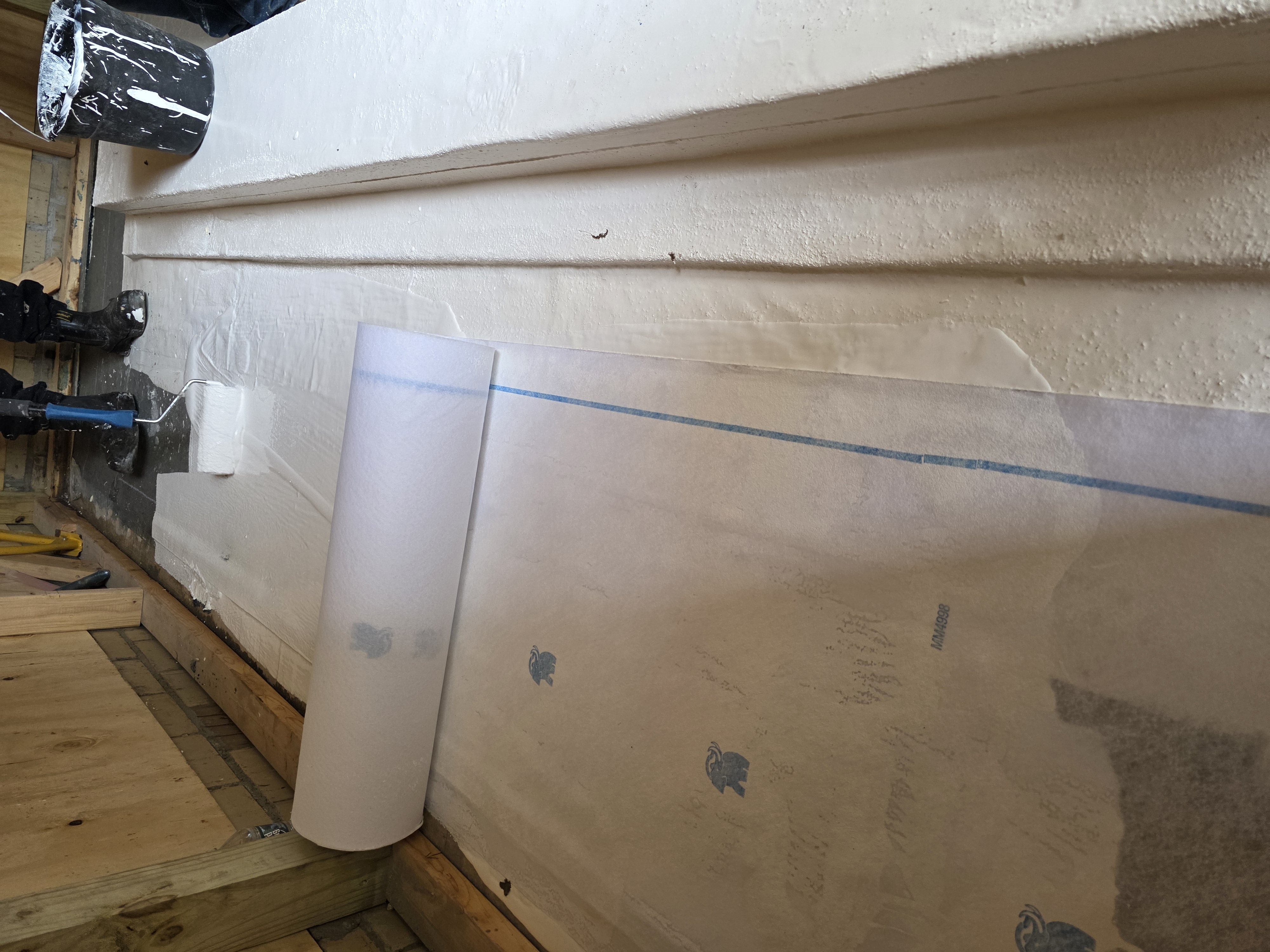 Foundation wall waterproofing membrane and sealant application in a basement